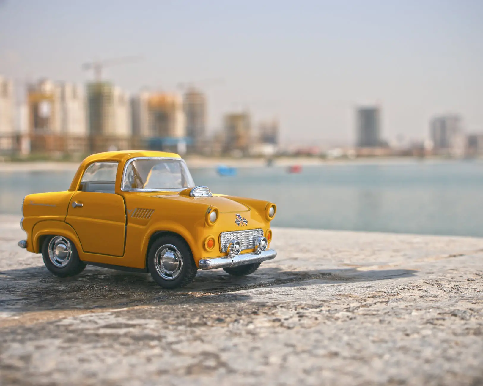 selective focus photography of yellow car toy